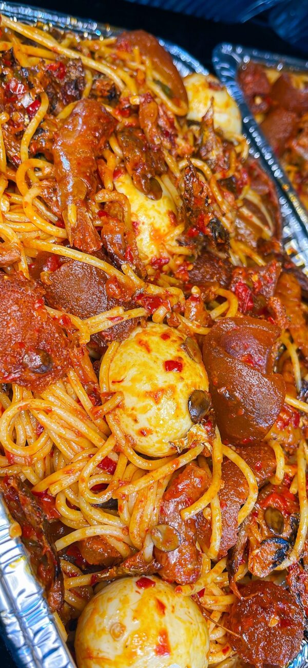 Native Spaghetti (Spaghetti elepo) with chopped ponmo, shredded fish, Crayfish and boiled egg (optional)